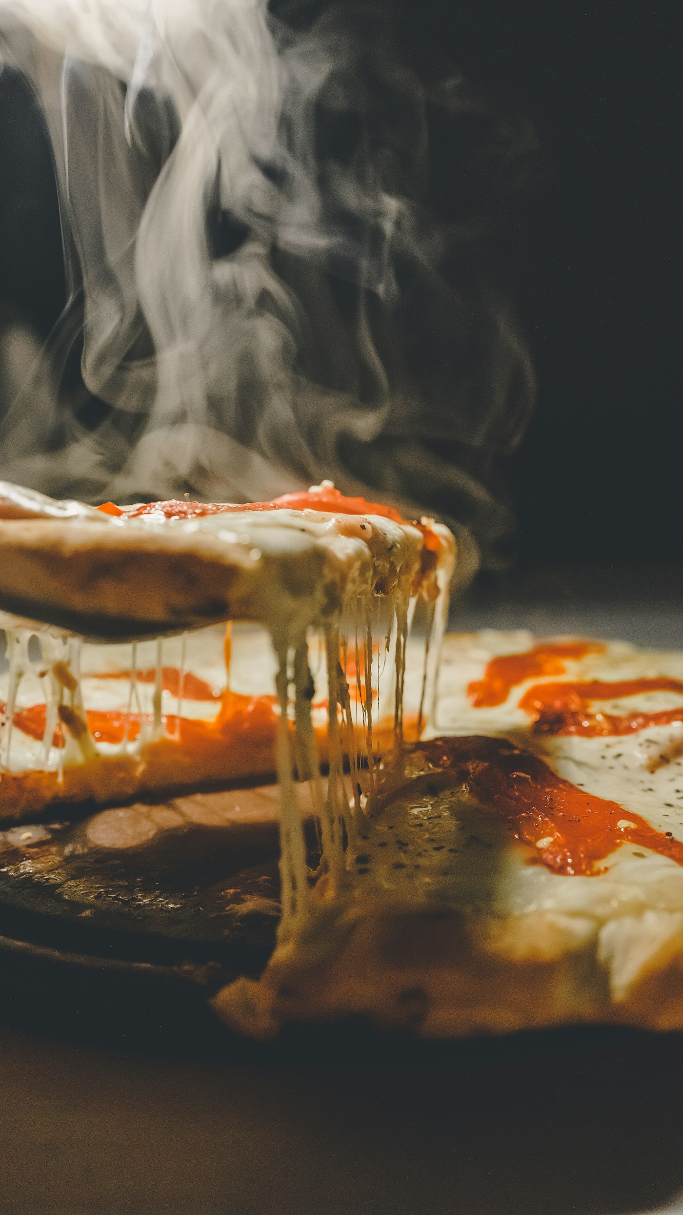 A slice pulled from a hot pizza